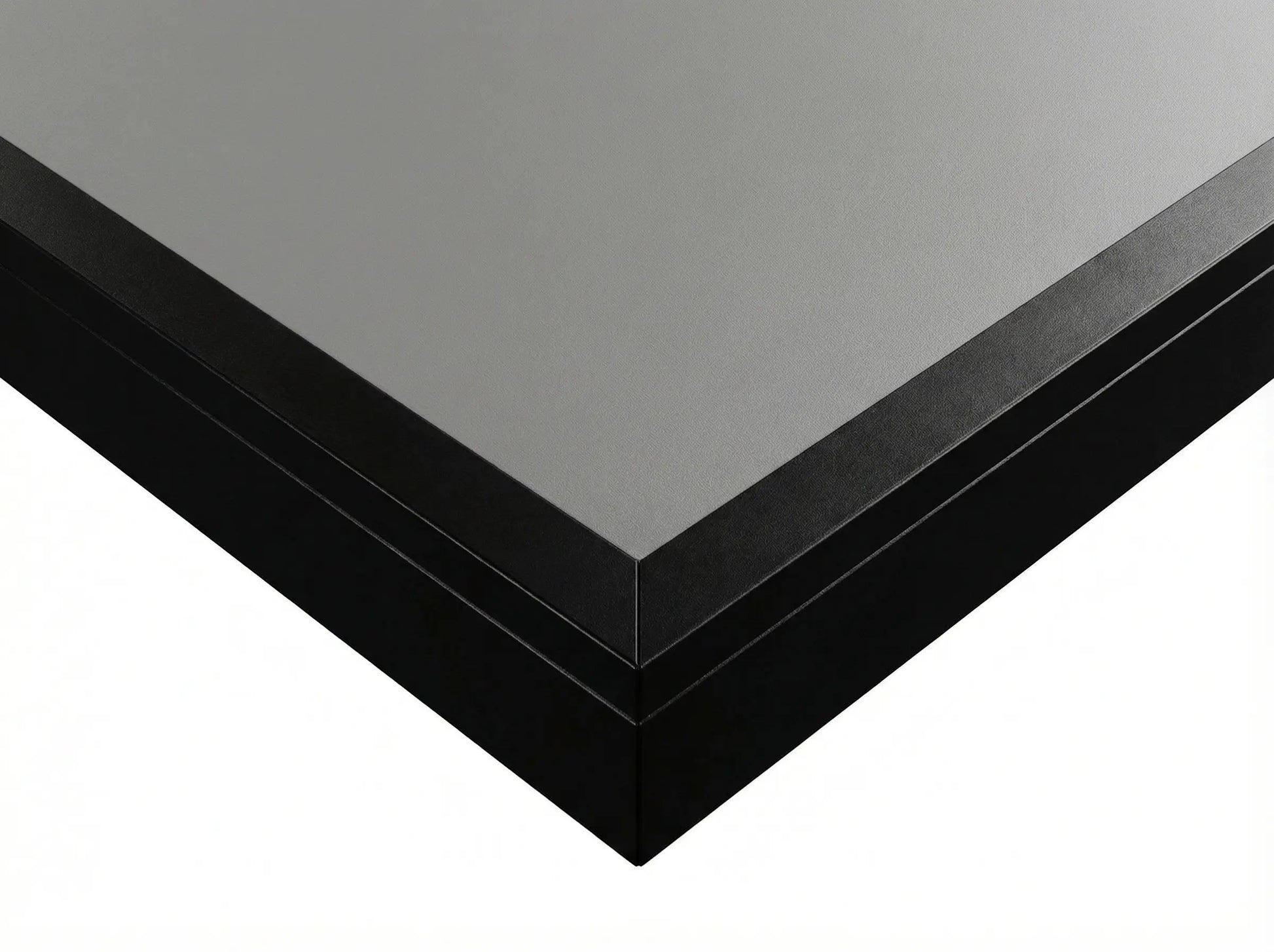Close-up of the gray engineered-wood playfield and black finished edge