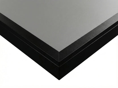Close-up of the gray engineered-wood playfield and black finished edge