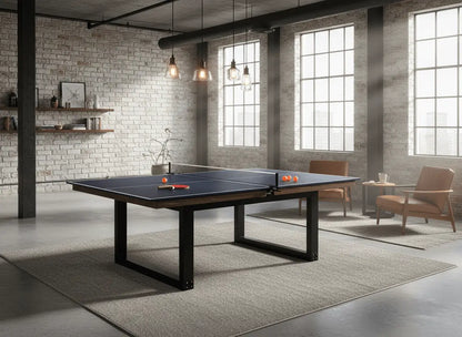 Blue table tennis playing surface in a bright industrial-style indoor loft